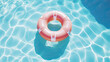 red inflatable ring floating in swimming pool. Vacation concept with copy space