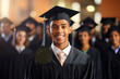 Portrait of African American male graduate standing in front of his collage friends.