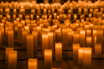 Wall Mural - Lots of candles on a church floor, candle light glowing orange
