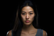Asian young adult woman portrait on black background. Neural network generated photorealistic image. Not based on any actual person or scene.