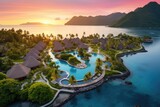 Fototapeta  - Aerial view of luxury hotel and resort at sea beach in tropical sea at sunset with beautiful colors.