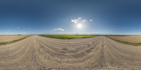 Wall Mural - 360 hdri panorama on gravel road with marks from car or tractor tires with clouds on blue sky in equ