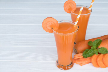 Wall Mural - Carrot smoothies yellow colorful fruit juice milkshake blend beverage healthy high protein the taste yummy In glass,drink to lose weight drink episode morning on white gray background.