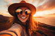 Female traveler taking a selfie at sunset