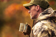 Hunter Wearing Camouflage Drinking a Coffee