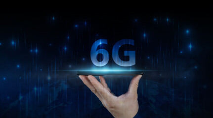 Wall Mural - businessman holding a smartphone with hologram 6g digital technology, access to information around t