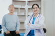 © Witoon - Female doctor talking taking care of her senior patient give support Doctor helping elderly patient with Alzheimer's disease A female attendant holds the hand of an elderly man