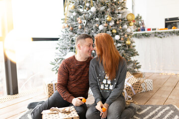 couple near the Christmas tree. the winter vacation. Christmas morning family celebrations