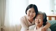 © ETAJOE - Asian Nurse hugging elderly patients during visit at home