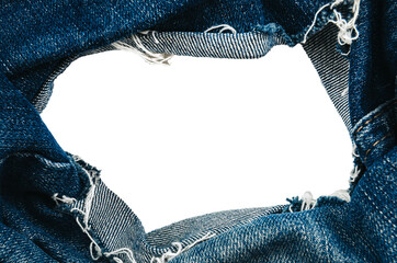 Wall Mural - Hole in denim on a white background. Ripped jeans