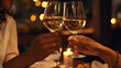 © vetre - Friends clinking glasses at Christmas day in restaurant.Happy young couple enjoying nice romantic dinner.
