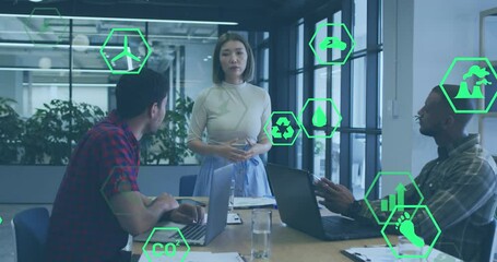 Wall Mural - Animation of icon in hexagons over diverse woman explaining strategy to coworkers in office