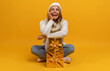 © mary_markevich - young smiling woman holding golden present boxes celebrating new year, christmas gifts