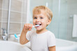 © Juha Saastamoinen - Smiling boy brushing teeth with toothbrush