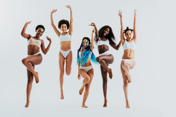 Wall Mural - Beauty portrait of beautiful black women wearing lingerie underwear - Pretty african young women posing in studio, concepts about beauty, cosmetology and diversity