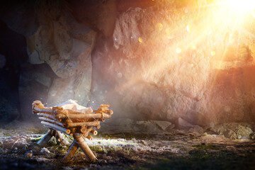 nativity - waiting birth of jesus christ with manger in cave with holy light and abstract defocused 