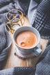 Fall season, leisure time, morning cocoa, sunday relax, hygge and still life concept. Cup of hot cocoa with warm knitted scarf and sweater