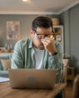 © Miljan Živković - Man overworked freelancer at home hold eyes eyestrain pain