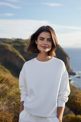 Wall Mural - Sweatshirt mockup a portrait photograph of a beautiful woman female standing outside in nature on a hill above the ocean beach sea