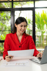 Wall Mural - Analytical research concept, Asian woman using calculator and laptop to do finance, mathematics on office table, taxes, reports, accounting, statistics.