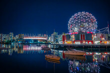 Skyline Of Downtown Vancouver, BC Place Stadium And Science World Museum At Night With Light Reflecting On Water, Boats In False Creek, British Columbia, Canada. Photo Taken In October 2021.