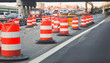 construction cones on a bustling urban street, symbolizing safety, roadwork, caution, and urban development