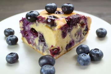 Wall Mural - Closeup of Mouthwatering Homemade Blueberry Cake Served with Fresh Blueberries