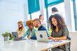 © unai - Man and woman sitting in a coworking using laptop
