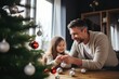 © radekcho - Father and daughter decorate a Christmas tree