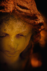 Canvas Print - Sweet expression of sad angel. Fragment of an ancient stone statue. Vertical image.