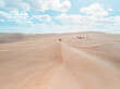 © AmazingAerialAgency - Aerial view of two people standing on a sand dunes in Port Lincoln National Park, South Australia.