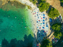 Aerial View Of People Relaxing At Gortanova Beach, A Narrow Inlet With Turquoise Water, Pula, Istria, Croatia.