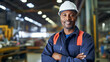 Portrait of smiling african american professional engineer factory. Engineering worker in safety hard hat at factory industrial facilities.