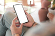 © panitan - cell phone blank white screen mockup.hand holding texting using mobile on desk at office.background empty space for advertise.work people contact marketing business,technology