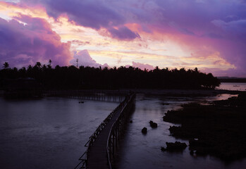 Wall Mural - Dusk and down on the seashore. Wooden bridge on a beach, Siargao Island Philippines.