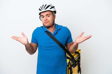 Wall Mural - Young caucasian man with thermal backpack isolated on white background having doubts while raising hands