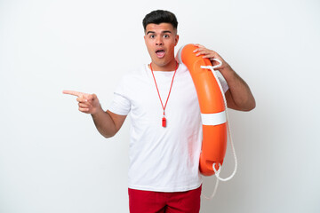 Wall Mural - Young handsome man isolated on white background with lifeguard equipment and surprised while pointing side