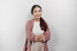 A confident smiling Asian woman employee wearing cardigan standing with arms folded and looking at the camera isolated over white background