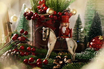 Wall Mural - Christmas decoration with vintage rocking horse figurine and nutcracker soldier ornament