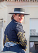 Joven y guapa jinete con traje andaluz a caballo en la feria de Fuengirola