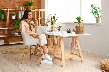 Poster - Young woman working with laptop at home office