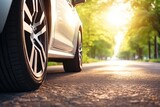 Fototapeta  - Summer tires on an asphalt road under the sun