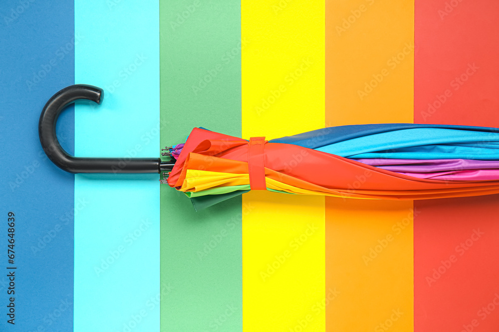 Stylish umbrella on colorful background
