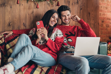 Sticker - Photo of cute people young wife using smartphone add wishlist tickets abroad winter holiday xmas while man browsing laptop indoors