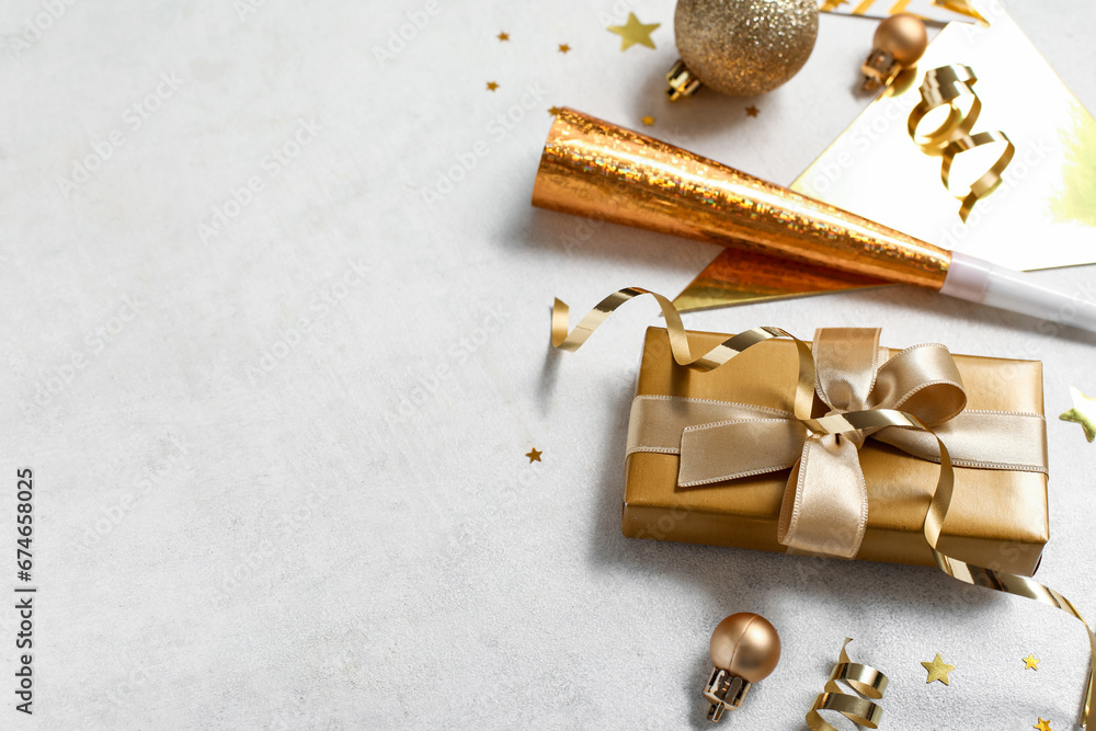 Beautiful composition with gift box and decorations for New Year party on white background