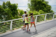 three young asian people running jogging outdoors