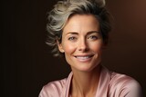 Fototapeta  - Close-up portrait of beautiful middle-aged woman with dreamy smile. Mature lady with grey hair and healthy face skin. Natural beauty, anti-wrinkle cosmetics, skincare concept. Black background.
