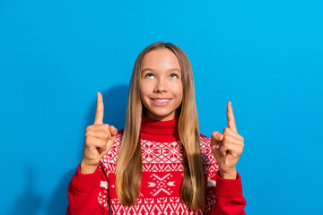 Sticker - Photo of optimistic nice adorable schoolgirl dressed red sweater directing look at offer empty space isolated on blue color background