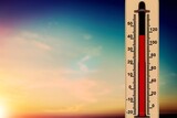 Fototapeta Natura - Thermometer with red degrees on sky background