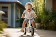Young Child Joyfully Riding Tricycle in Sunny Backyard